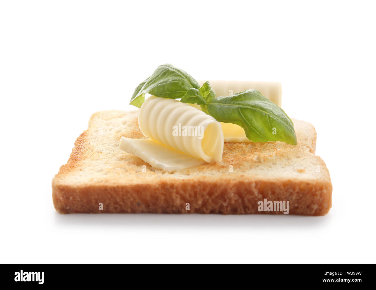 Slice of bread with butter curls on white background Stock Photo - Alamy