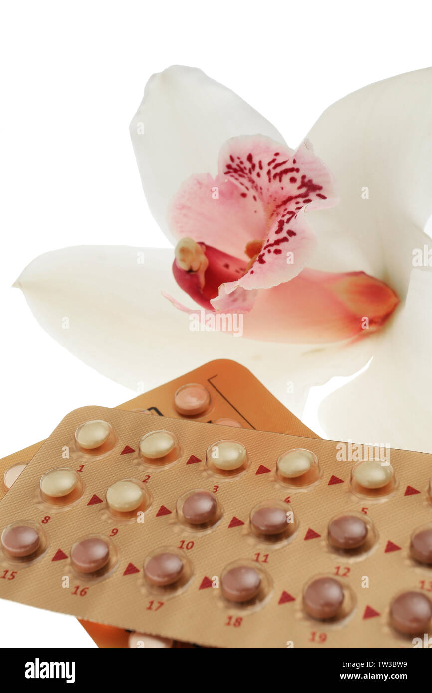 Oral contraception concept. Birth control pills and orchid flower on white background, closeup Stock Photo