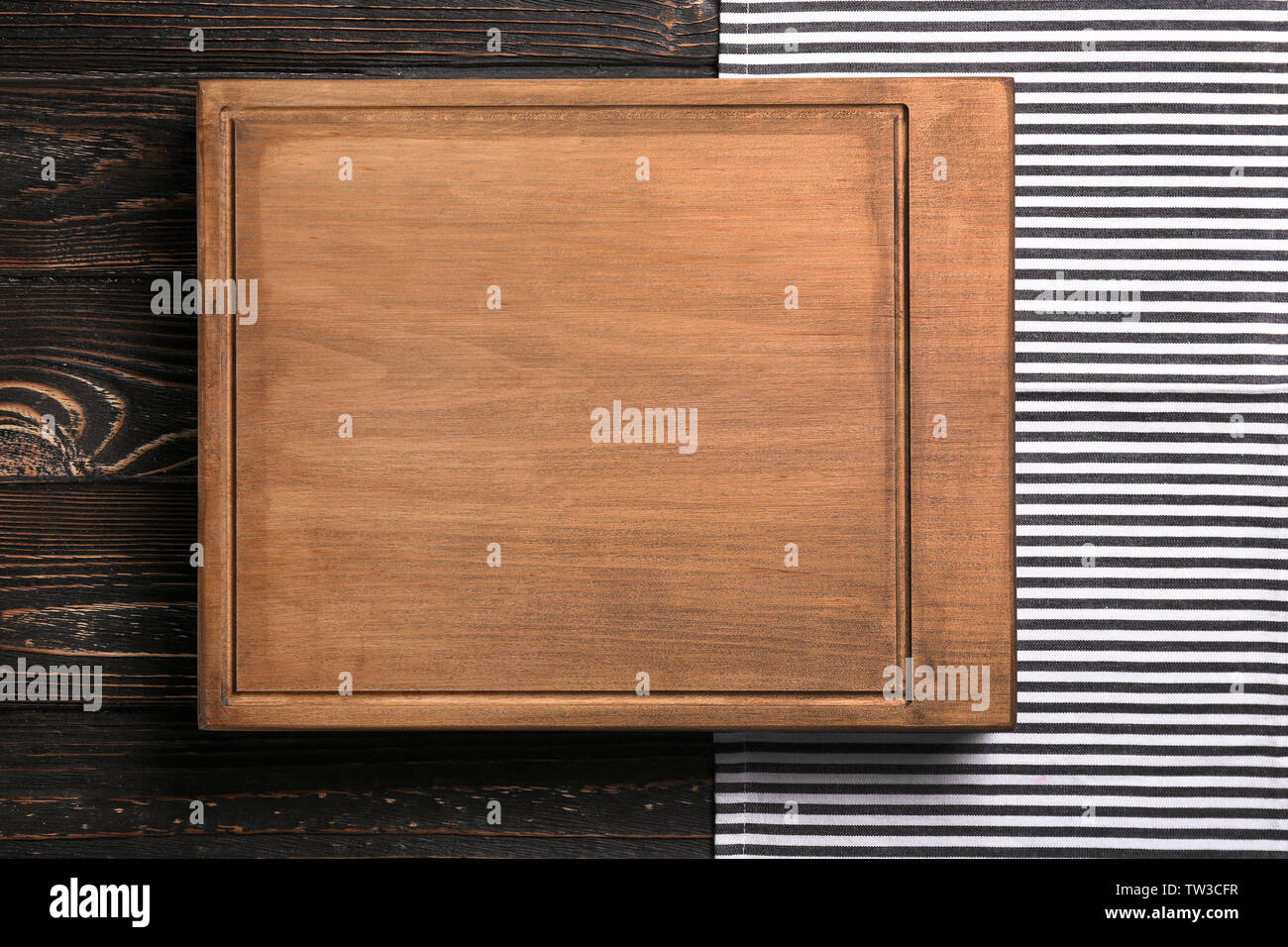 Rectangular cutting board on wooden table Stock Photo