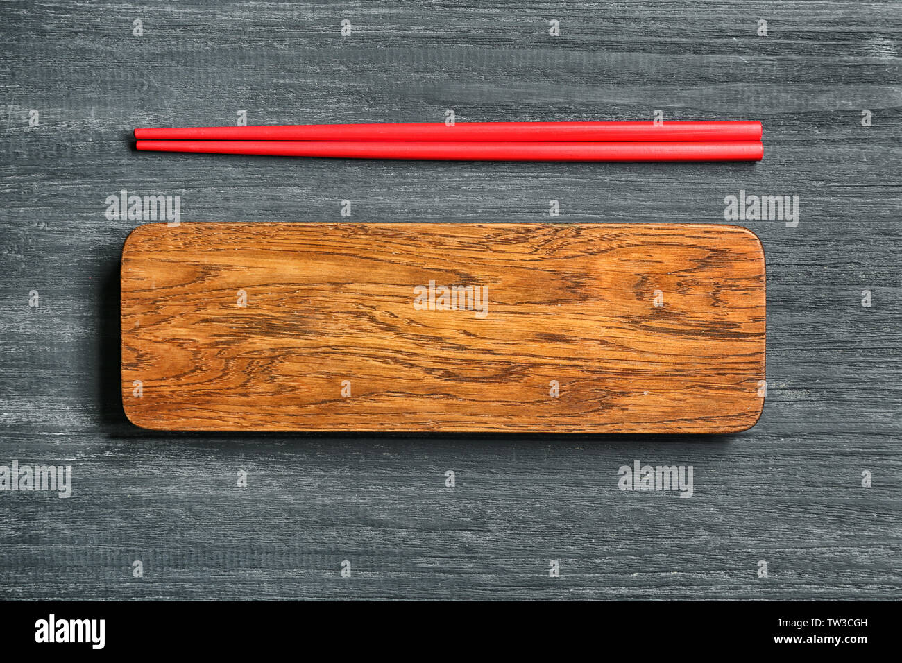 Rectangular wooden board and chopsticks on table Stock Photo