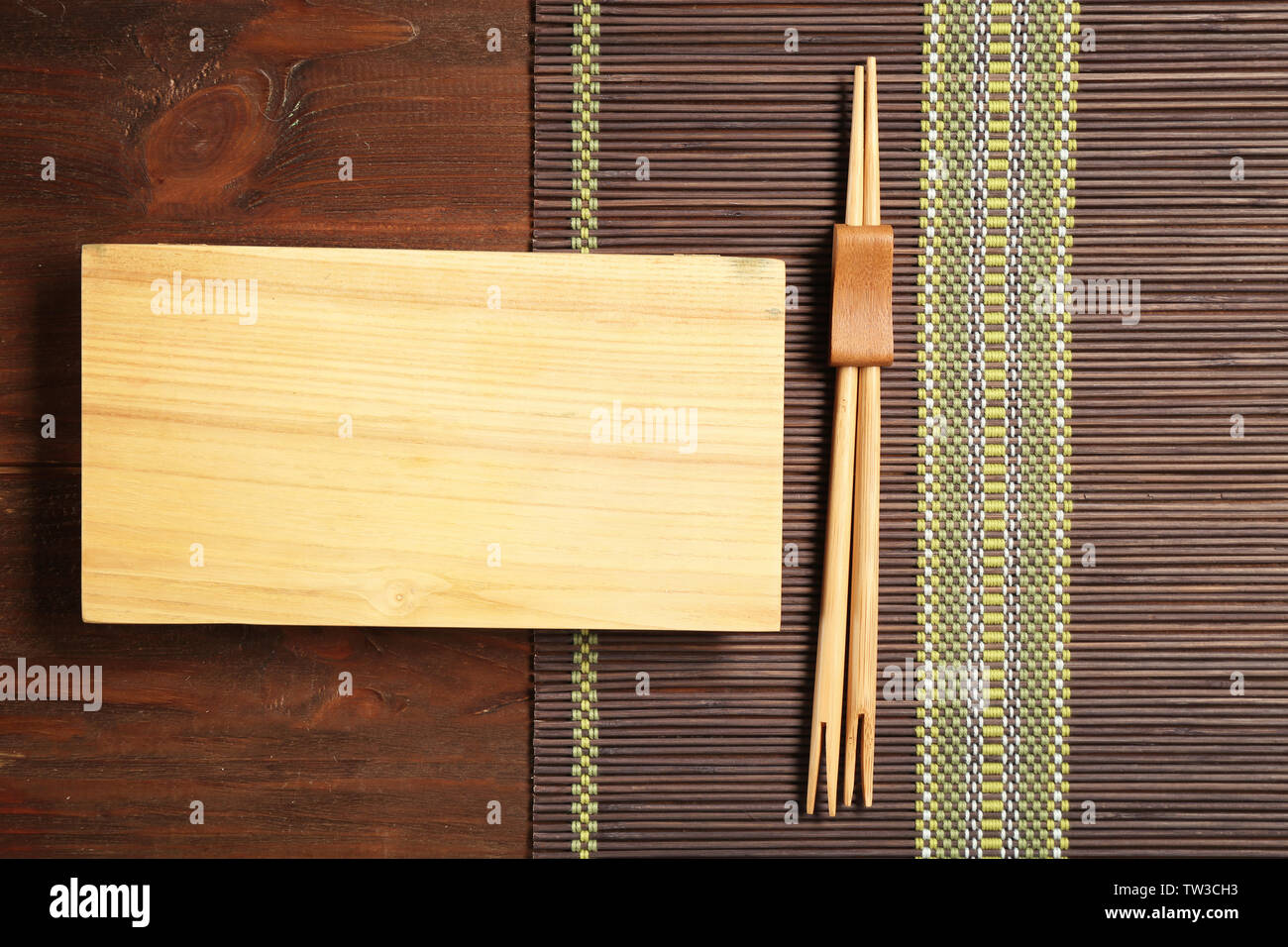 Rectangular wooden plate and chopsticks on table Stock Photo