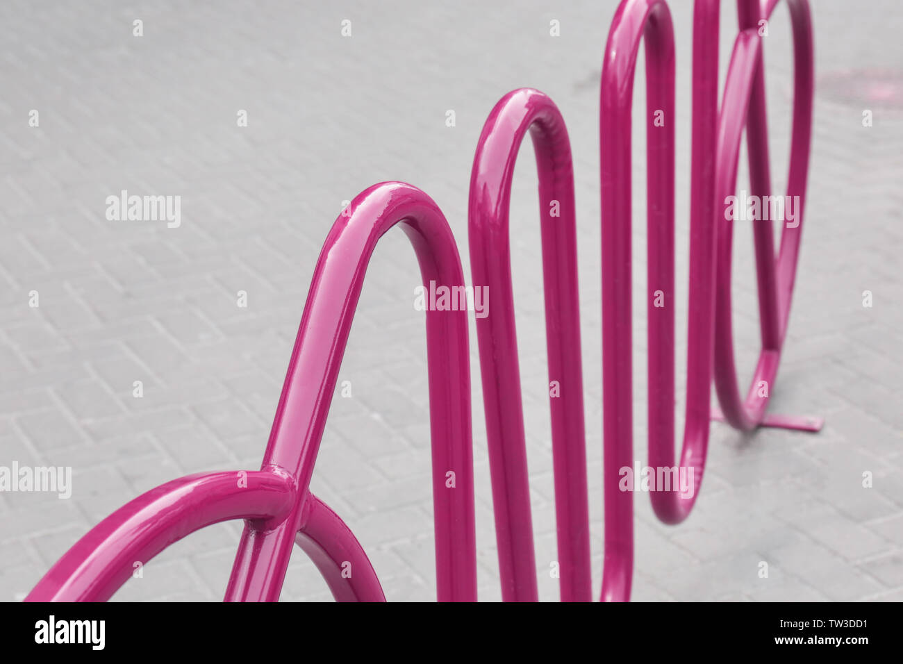 Empty colorful bicycle rack on sidewalk Stock Photo - Alamy