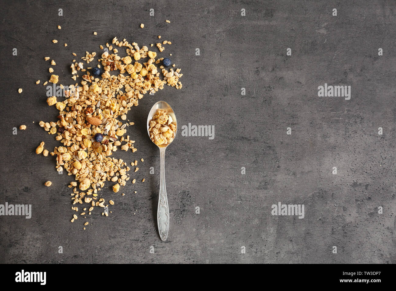 Silver spoon with muesli on gray background Stock Photo