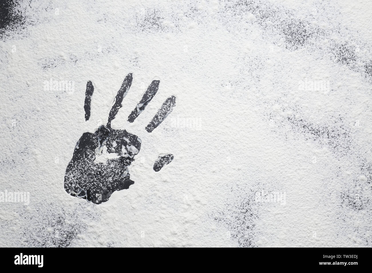Hand print on scattered flour Stock Photo