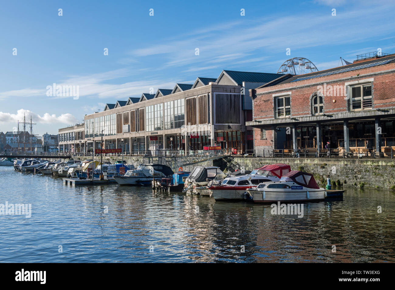 The Floating Harbour at Bristol on a sunny blue sky winter day showing moored boats and people in this bustling west country city. Stock Photo