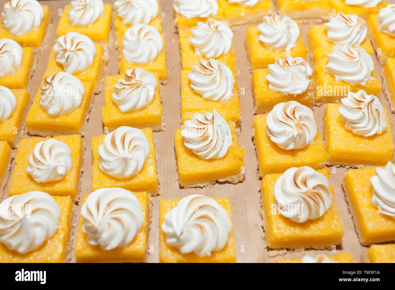 Custard pie with meringue lined up decorated on dessert buffet. Sweet paradise. Stock Photo