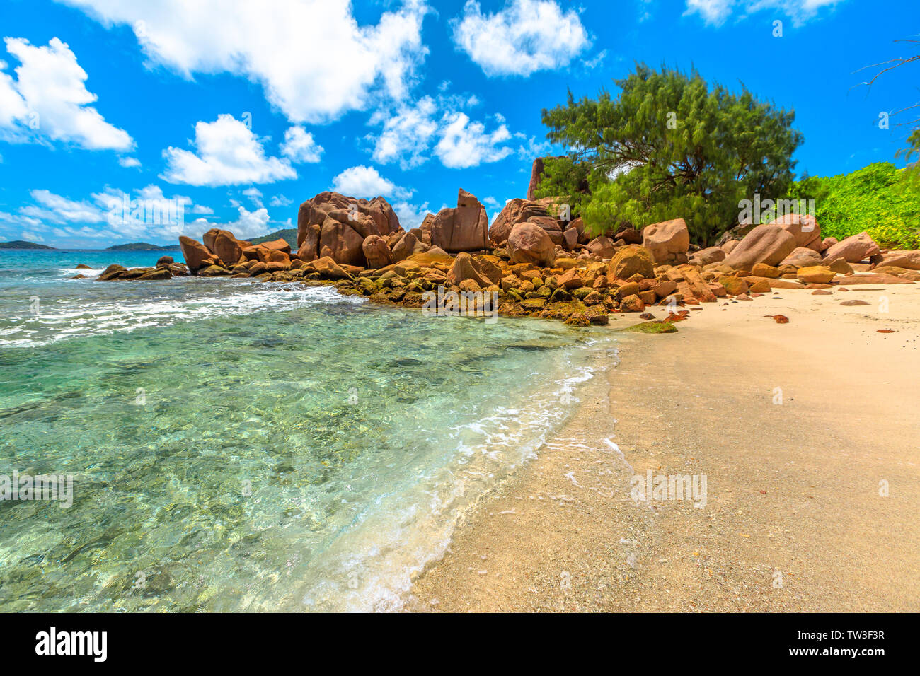 Turquoise waters of Anse Caiman, La Digue, Seychelles, reached with a trek in the forest and is far from tourist routes. Anse Caiman and pristine Stock Photo