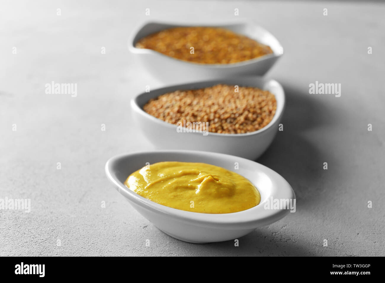 Gravy boat with delicious mustard sauce on table Stock Photo