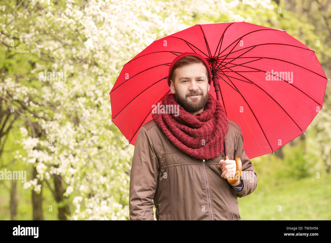 Portrait of handsome young man with umbrella Stock Photo - Alamy