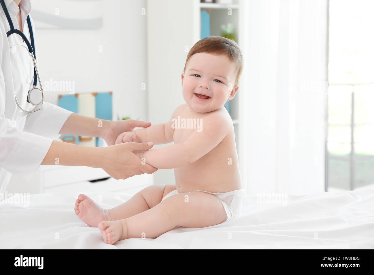 Doctor examining little baby in clinic. Baby health concept Stock Photo ...