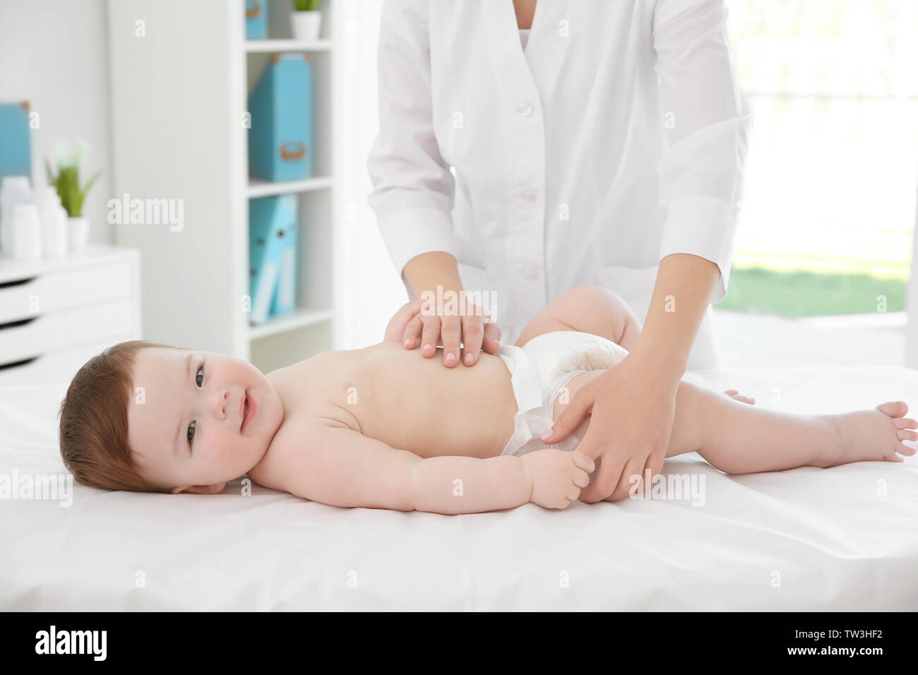 Doctor examining little baby in clinic. Baby health concept Stock Photo ...