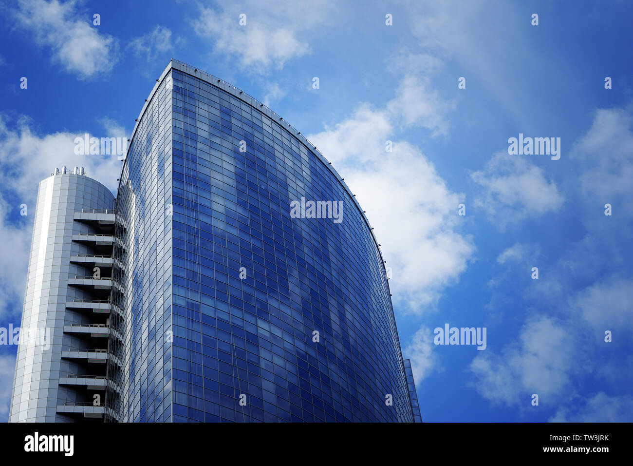 Building with tinted windows against blue sky Stock Photo