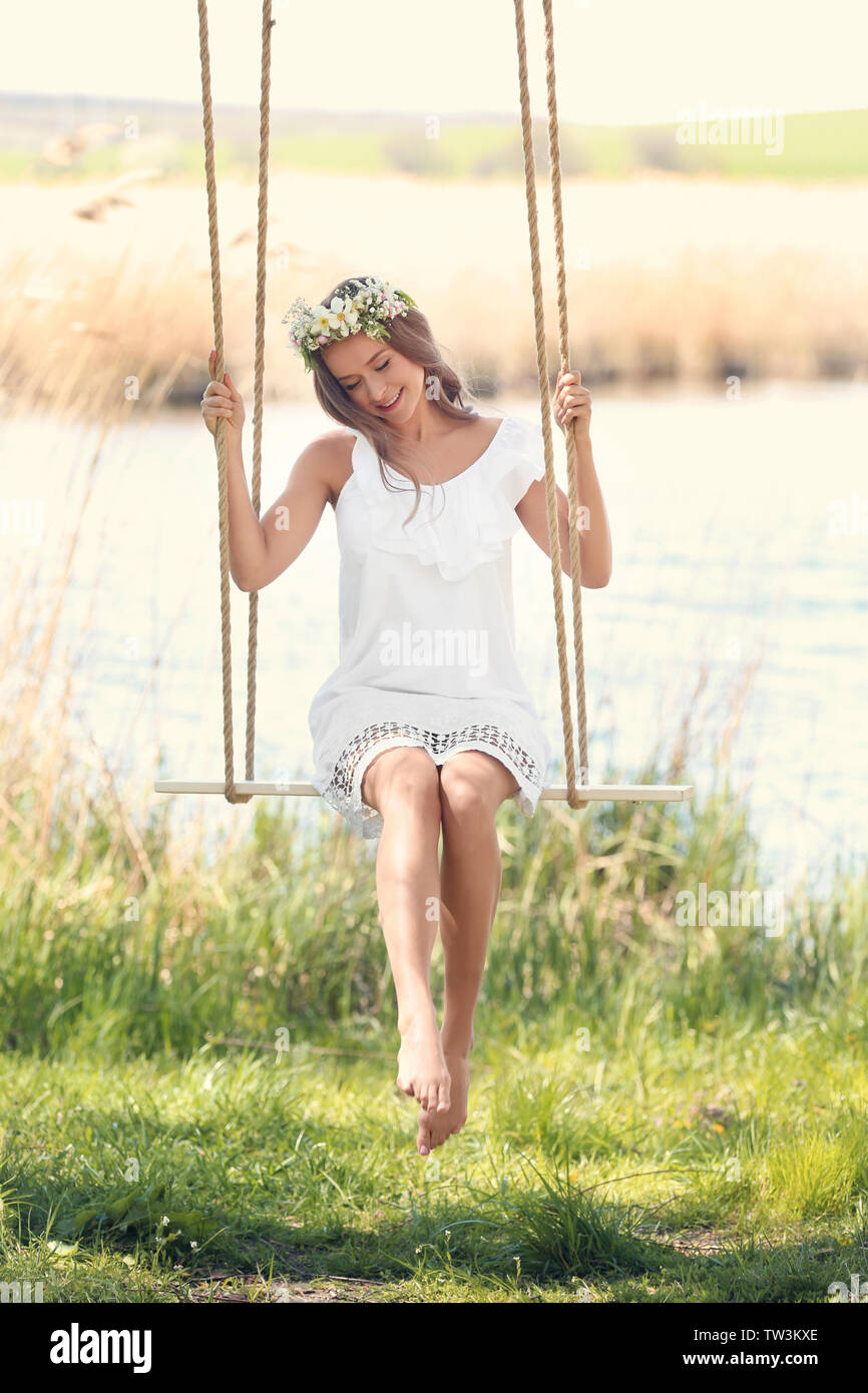 Woman on swing hi-res stock photography and images - Alamy