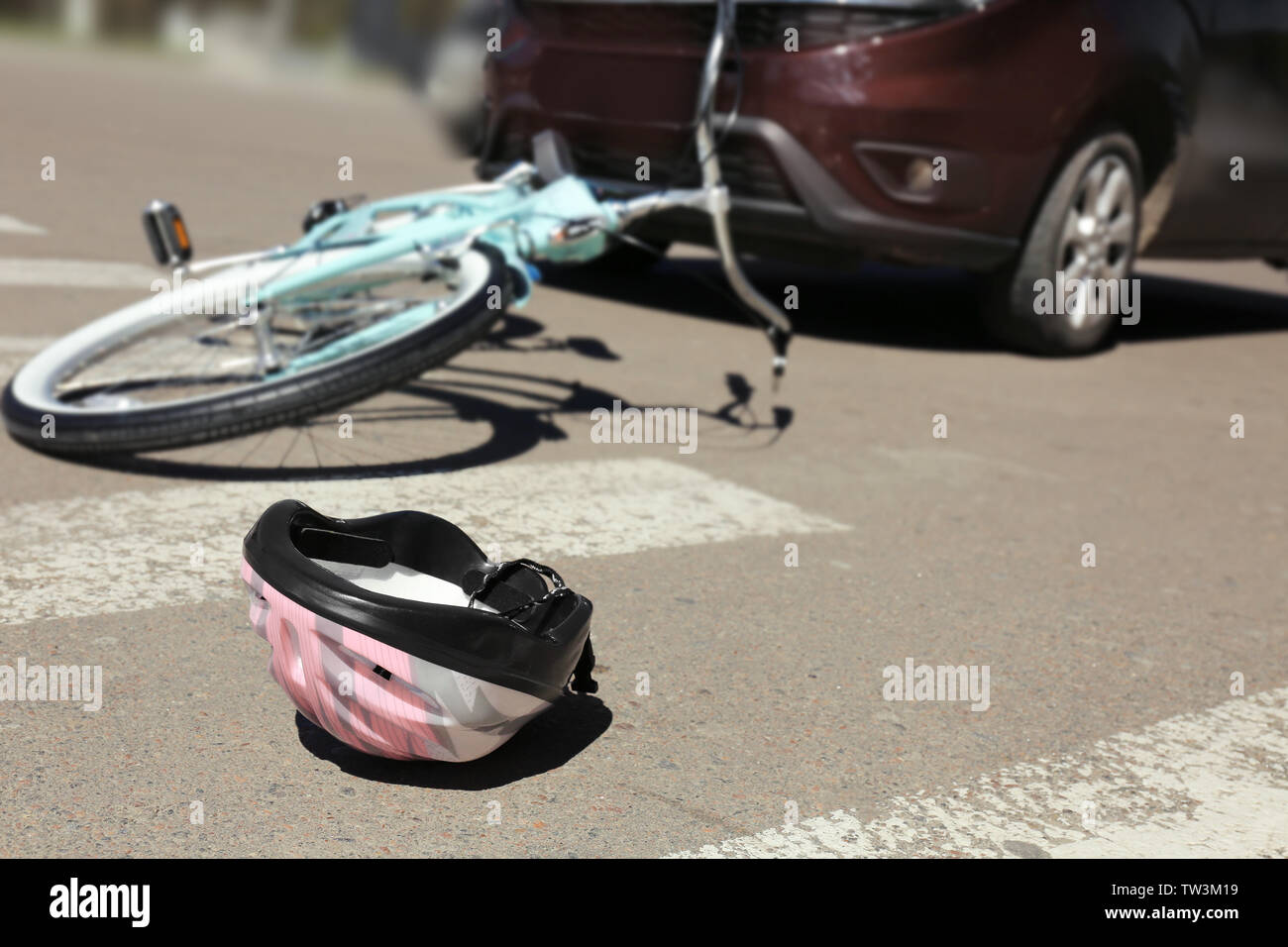 Helmet lying on zebra crossing near accident place Stock Photo