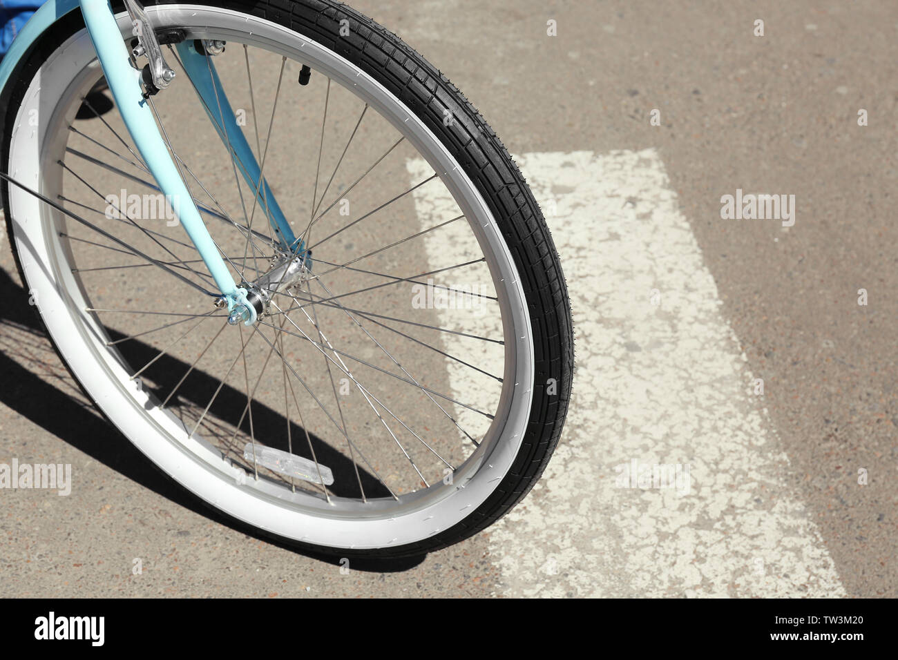 Bicycle wheel on zebra crossing, outdoor Stock Photo
