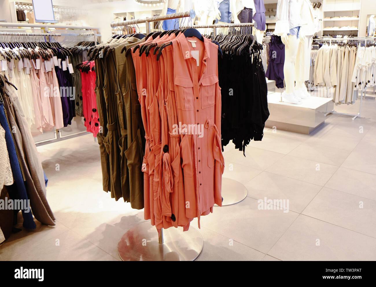 Different female clothes in modern shop Stock Photo Alamy