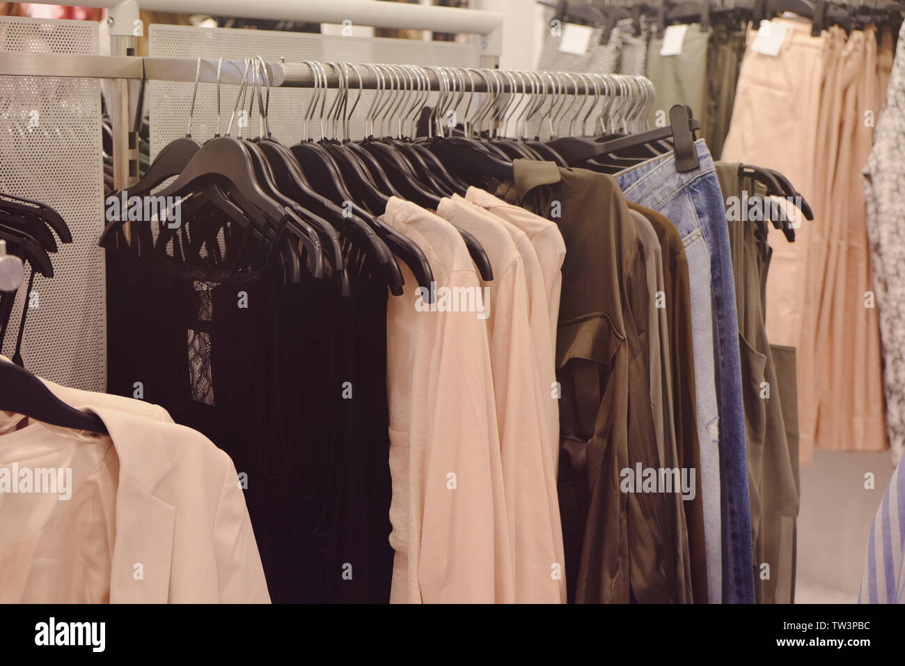 Different female clothes in modern shop Stock Photo Alamy