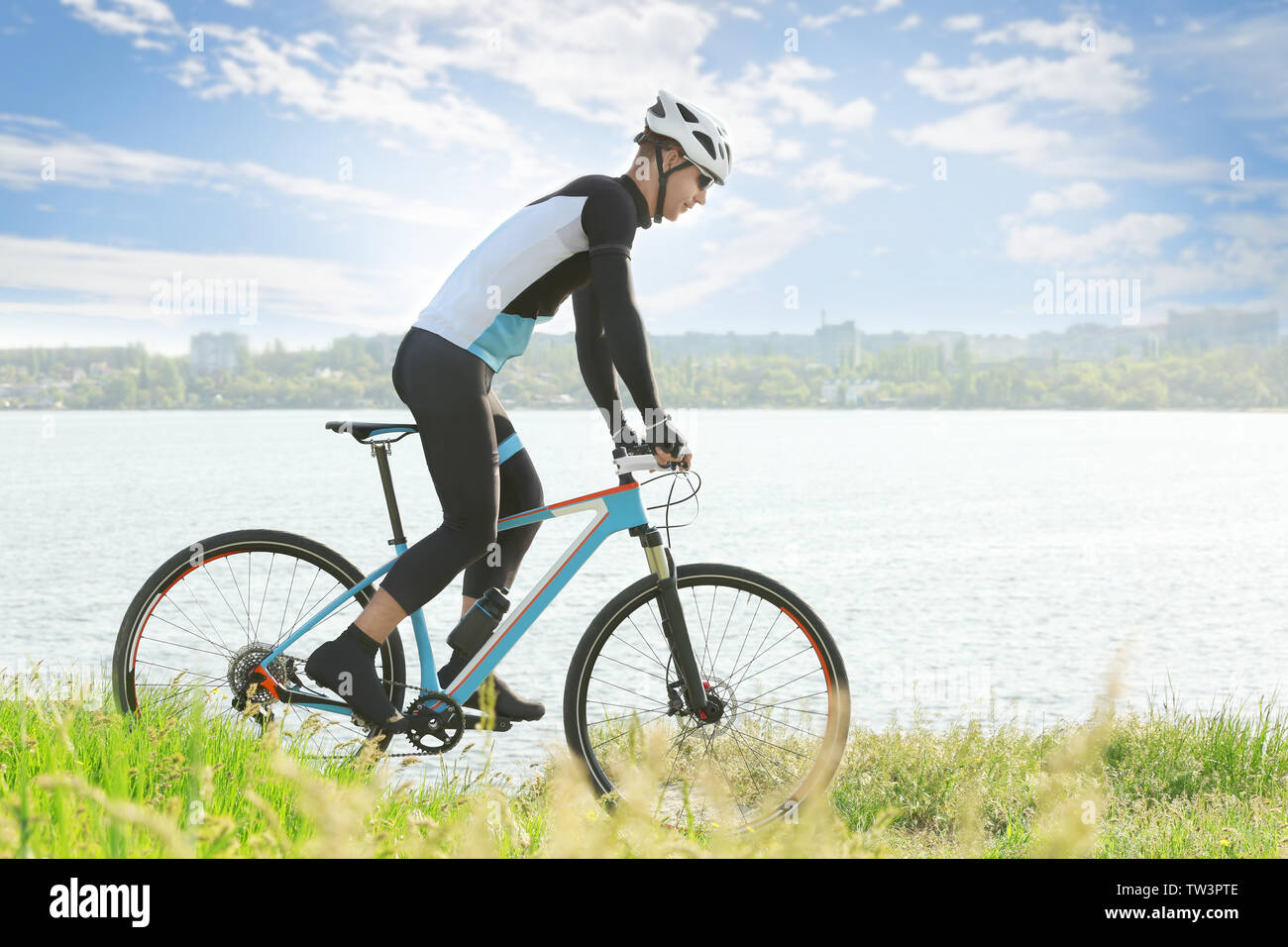 Bicycle Rideing Sporty cyclist riding bicycle near river Stock Photo - Alamy