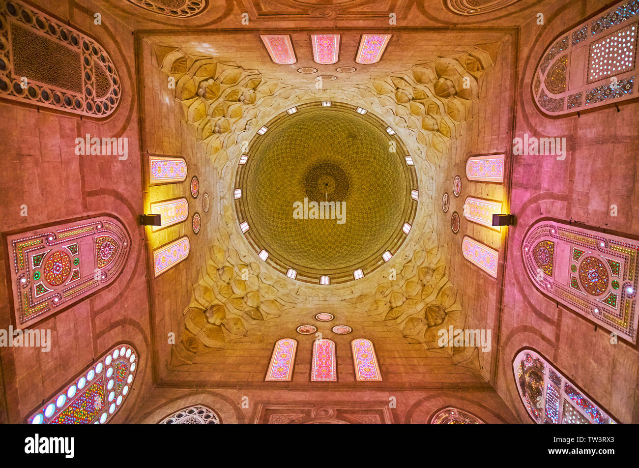 CAIRO, EGYPT - DECEMBER 22, 2017: The beautiful carved stone dome of Amir Khayrbak Mausoleum with muqarnas decoration and fine stained glass windows, Stock Photo