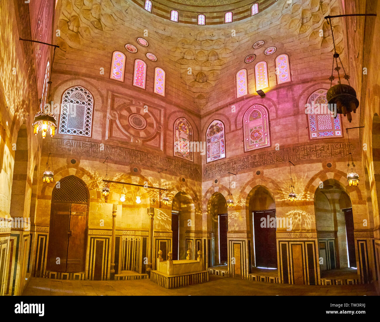 CAIRO, EGYPT - DECEMBER 22, 2017: The scenic medieval building of Amir Khayrbak Mausoleum with carved walls, covered with colorful shades of stained g Stock Photo
