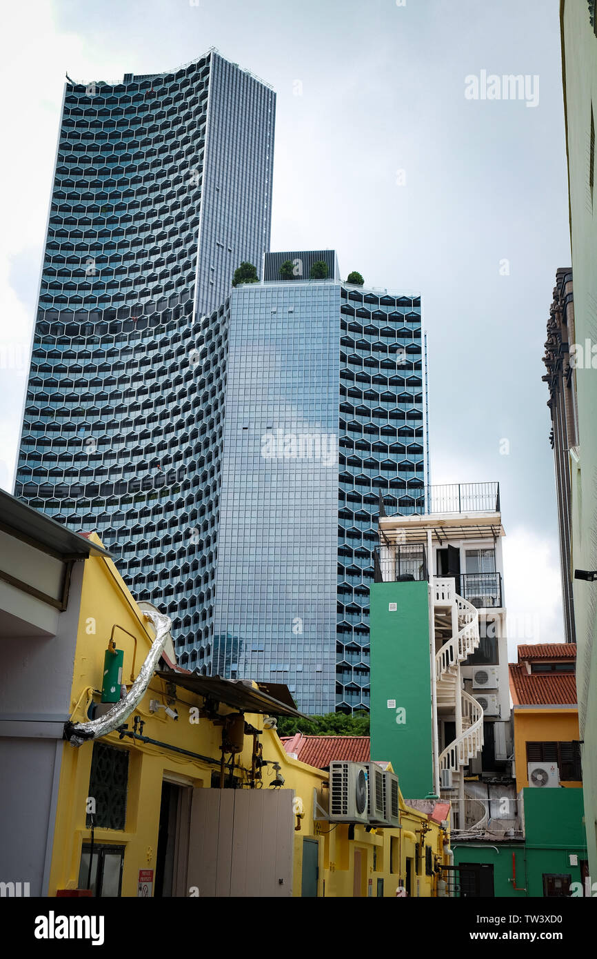 Modern Duo towers in Singapore showing contrasting design overlooking the small residential traditional homes in the bugis haji lane  area Stock Photo