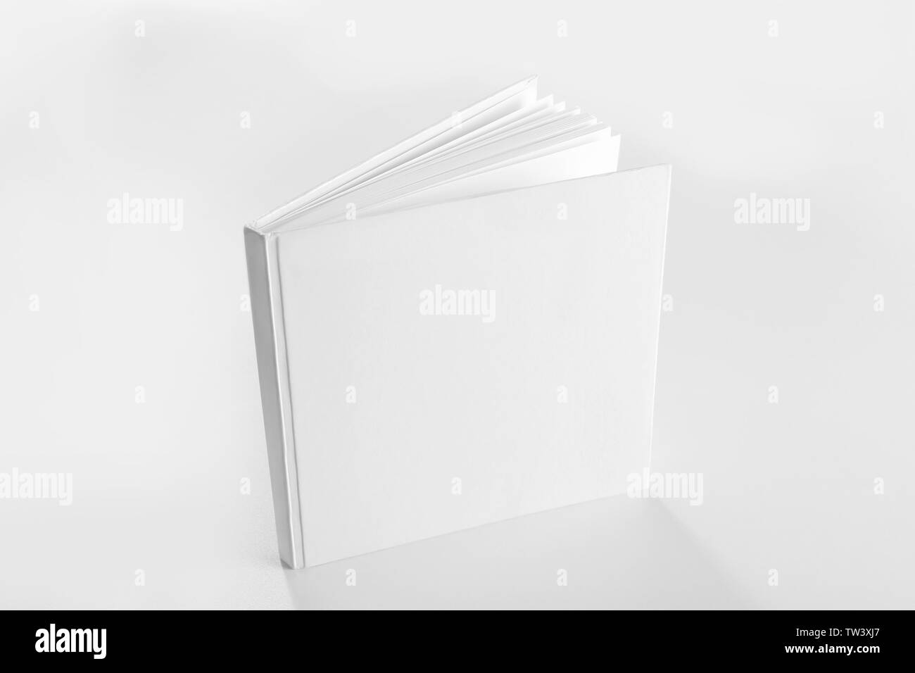 Book with blank cover on light background Stock Photo - Alamy