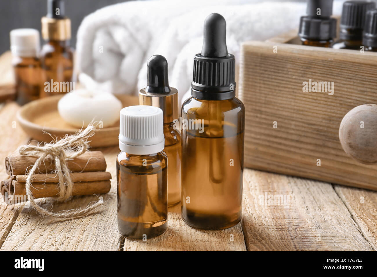 Composition with bottles of cinnamon oil on wooden background Stock Photo