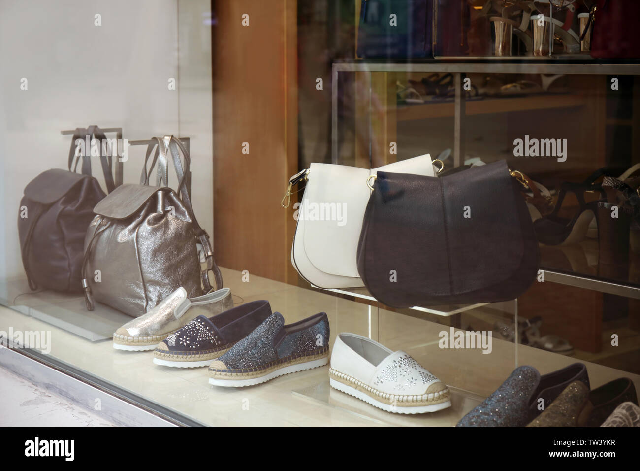 View through showcase on shoes and accessories in shop Stock Photo Alamy