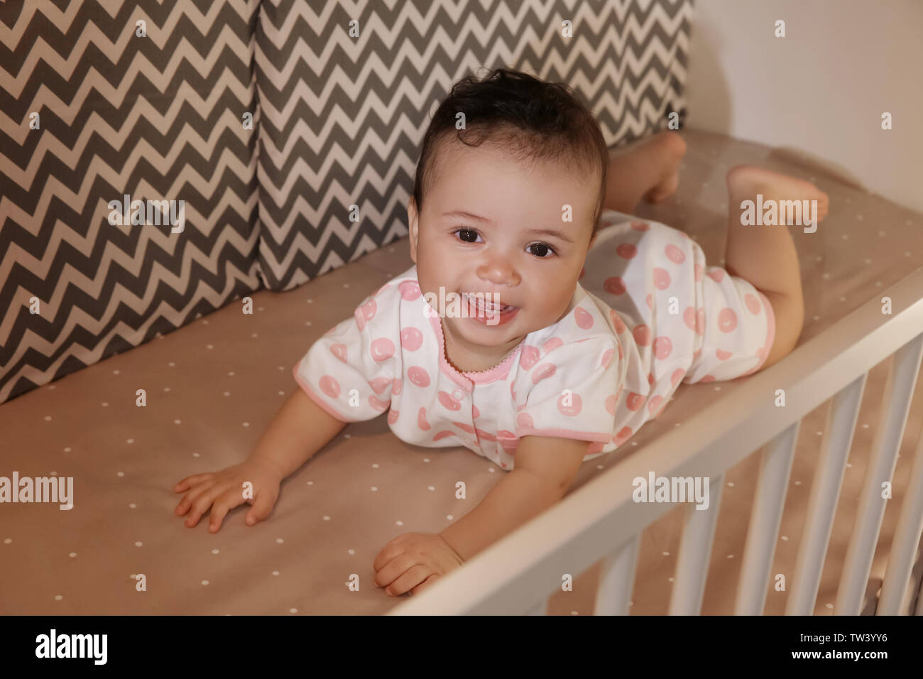 Cute little baby lying in cradle at home. Sleep disorders concept ...