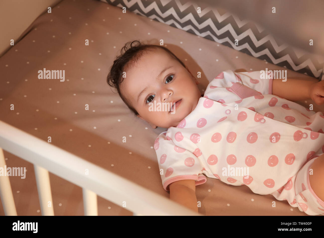 Cute little baby lying in cradle at home. Sleep disorders concept Stock Photo
