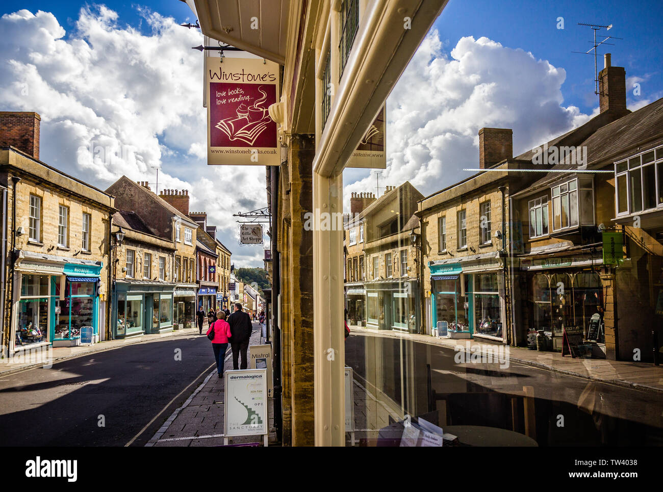 With of Cheap Street and shops with reflections in window in Sherborne