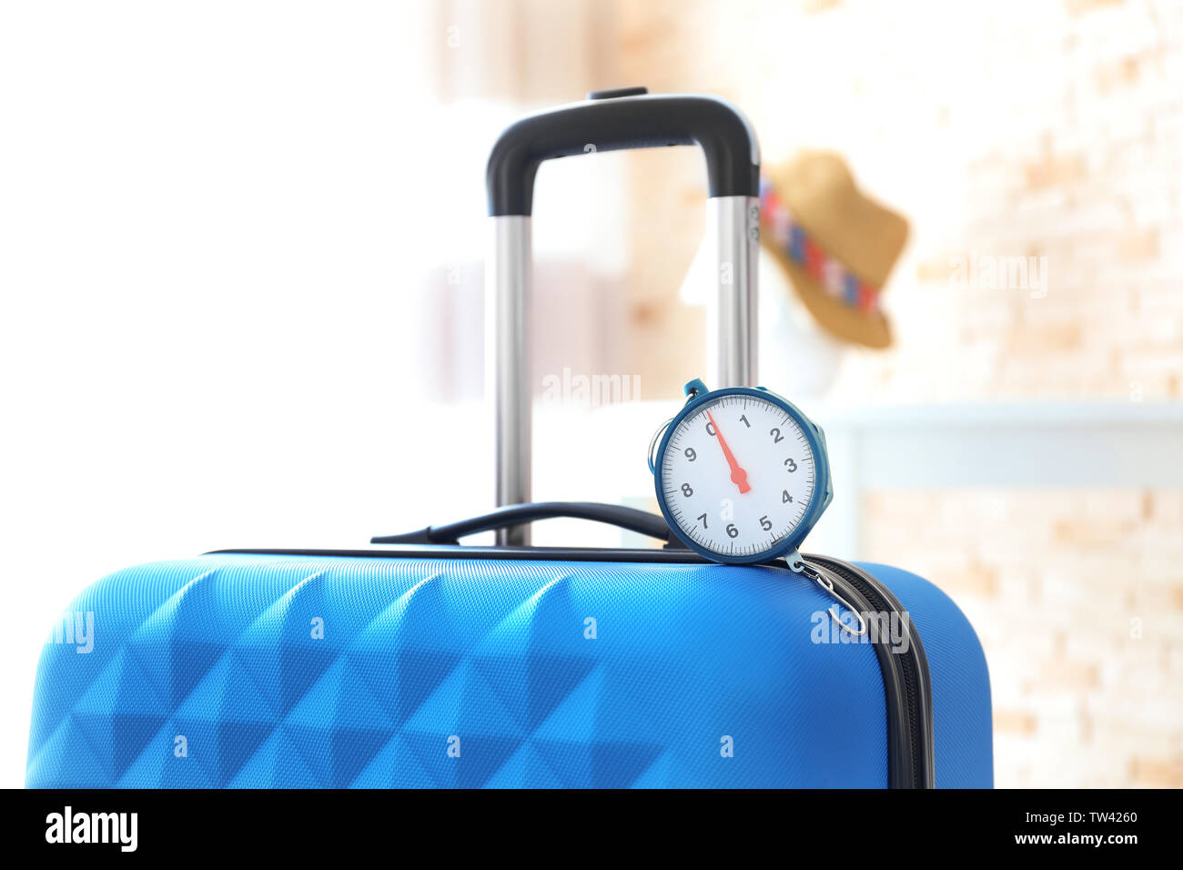 Scales on heavy suitcase. Luggage overweight concept Stock Photo Alamy