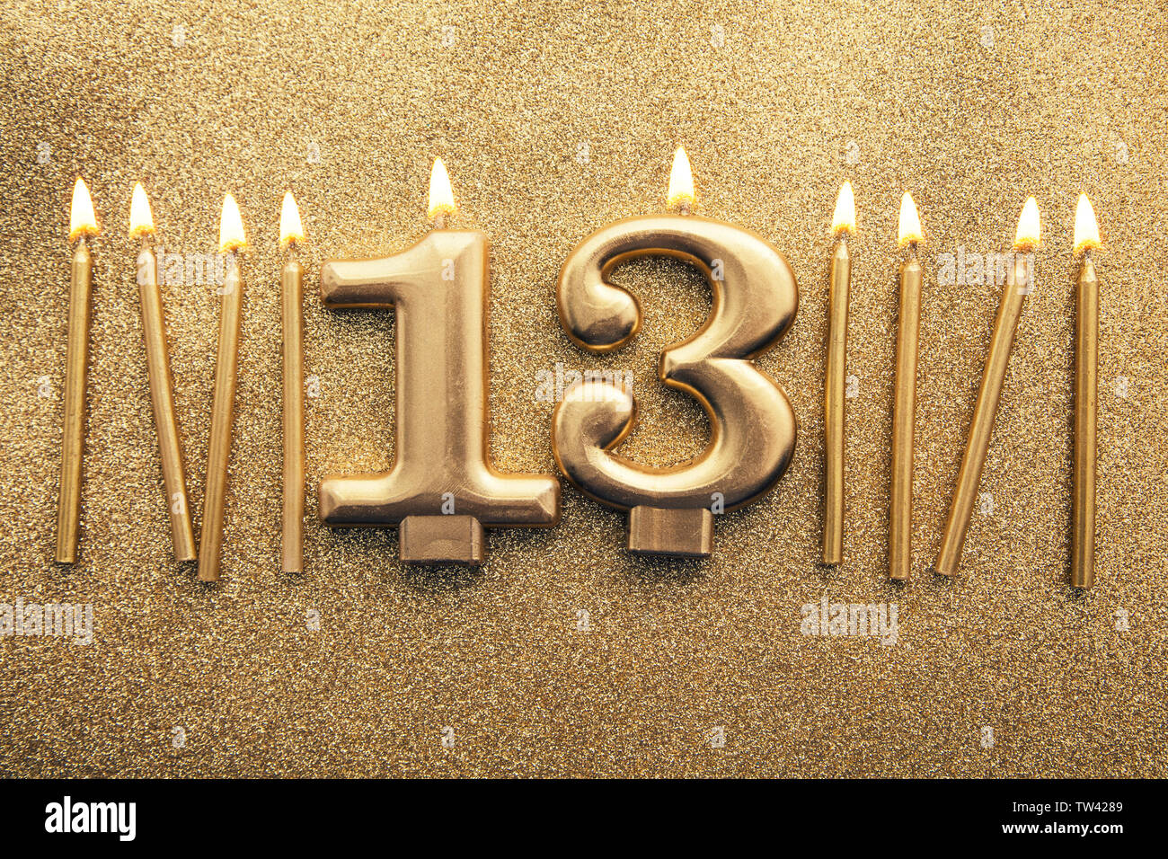 Number 13 gold celebration candle on a glitter background Stock Photo ...