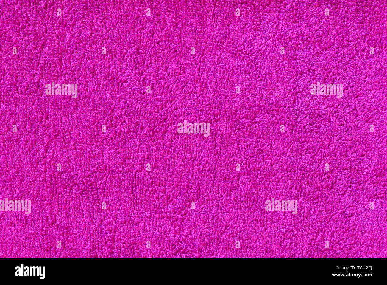 Pink terry towel background. Close-up fabric texture. Top view. Copy space. Vertical photography. Stock Photo