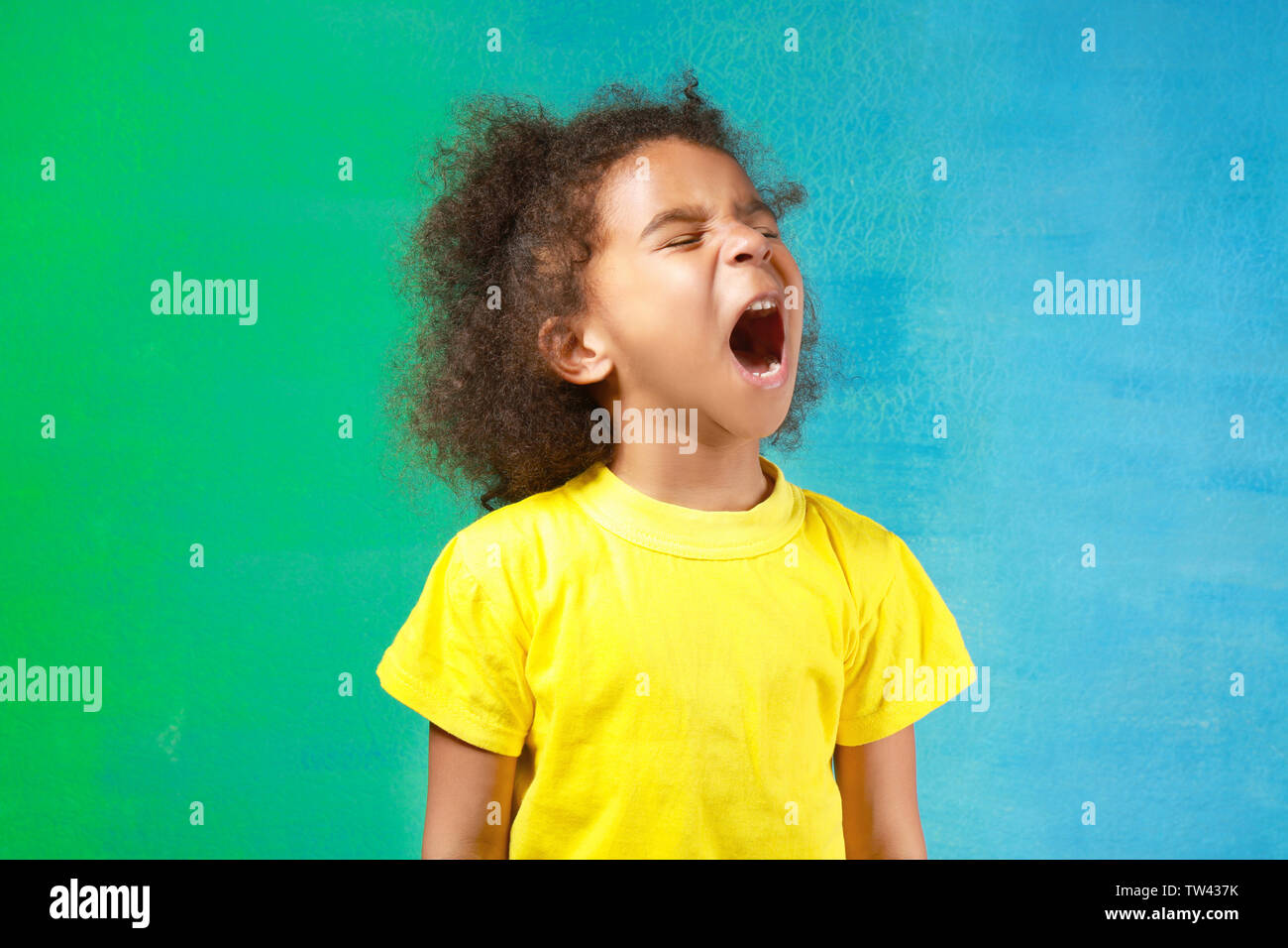 Cute little African girl on color background Stock Photo - Alamy