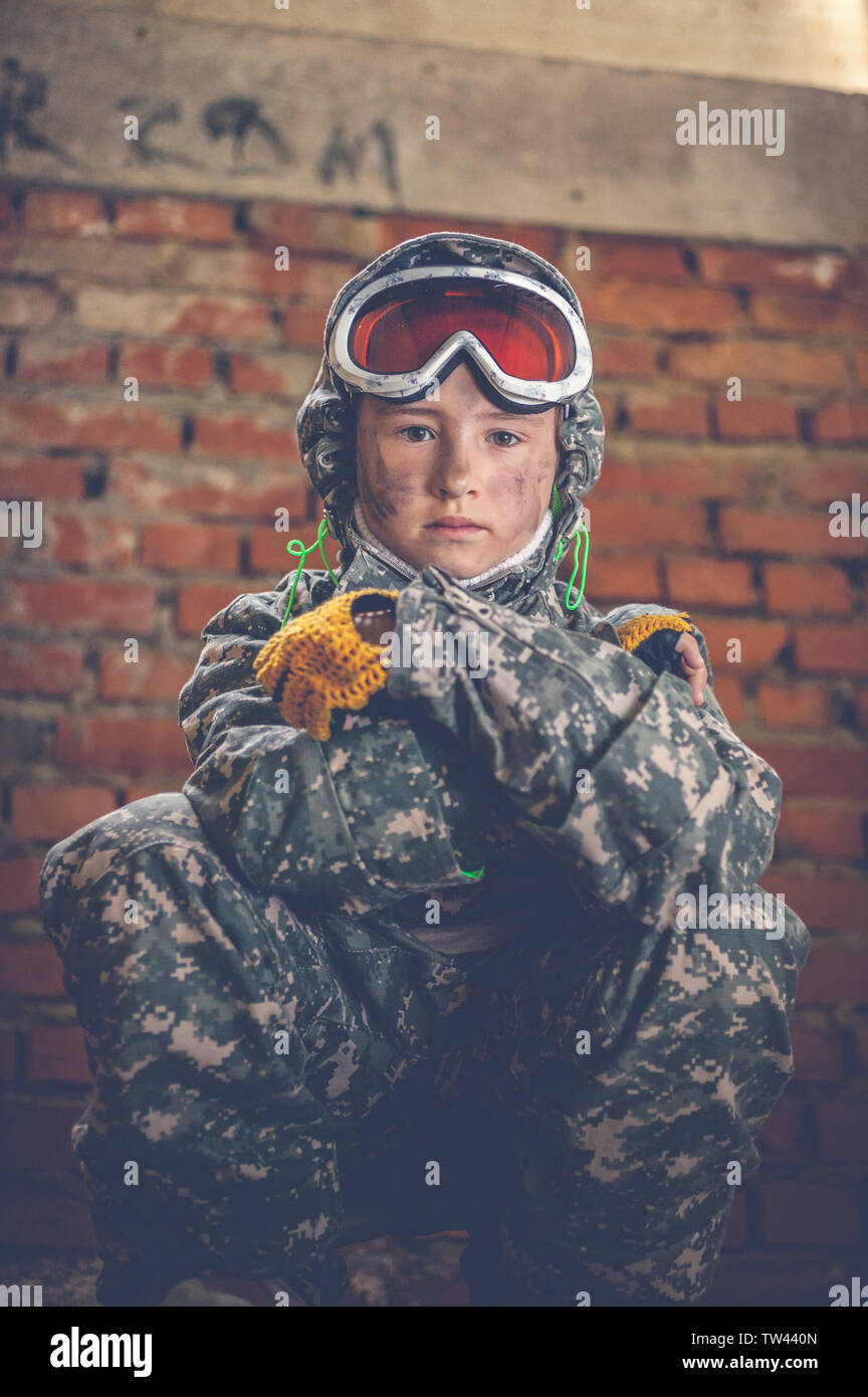 Stalker girl in camouflage is hiding in a destroyed building. Photoset based on the game Chernobyl. Exclusion Zone. Nuclear post-apocalypse Stock Photo