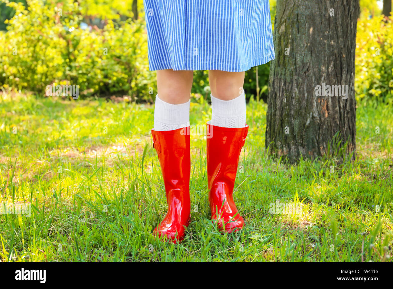 Young woman in red wellington boots outdoors Stock Photo