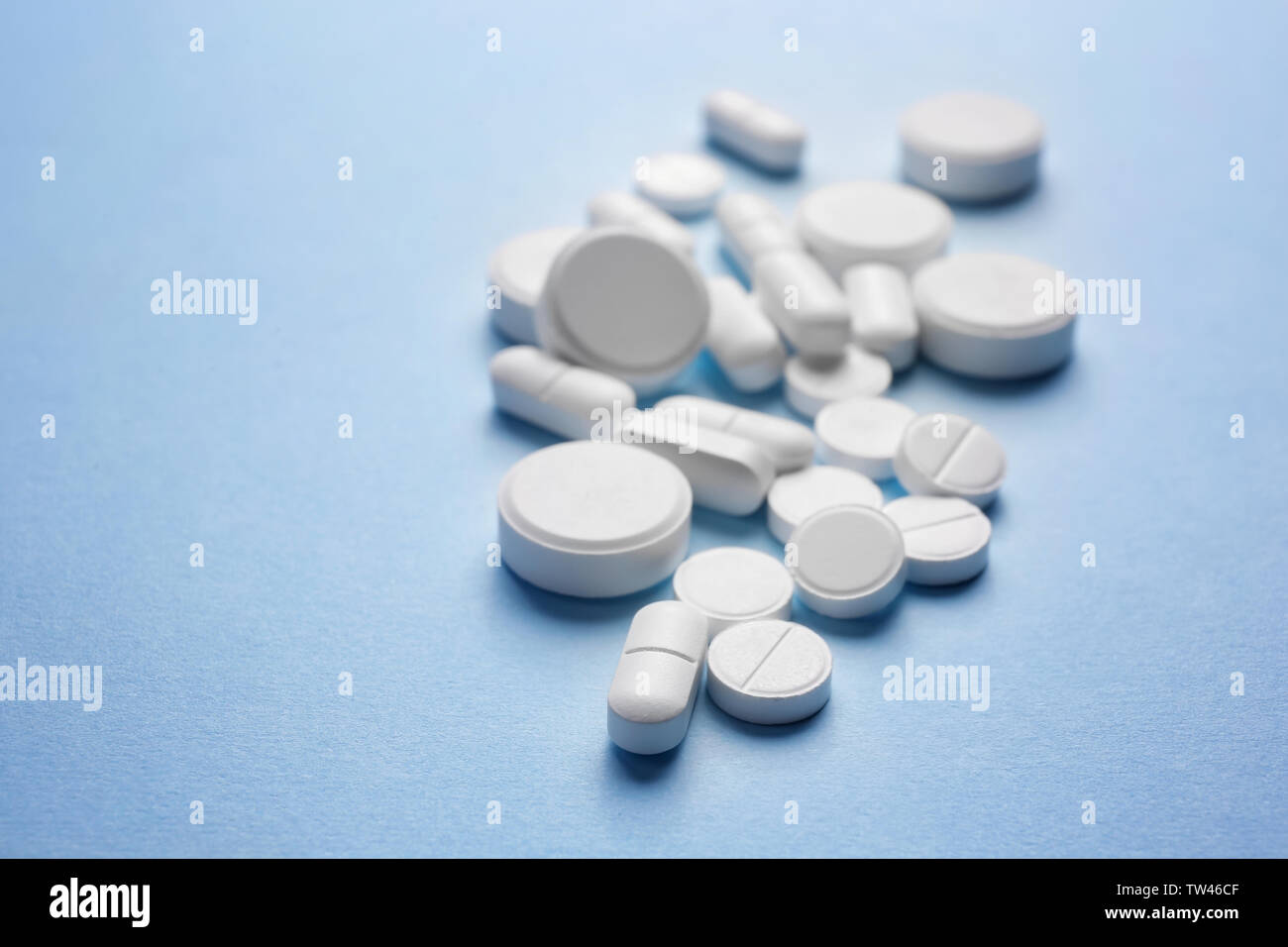 White pills on color background Stock Photo