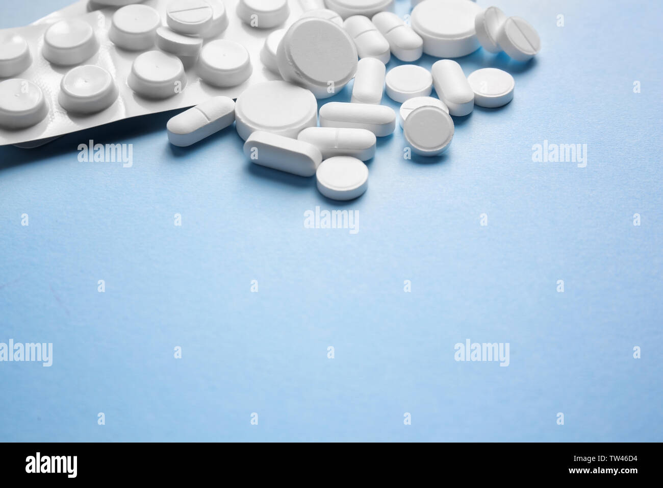 White pills on color background Stock Photo