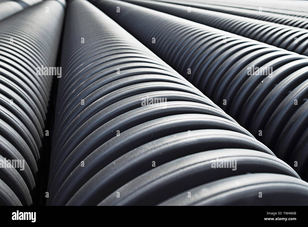 Close up of black plastic pipes with diminishing perspective Stock