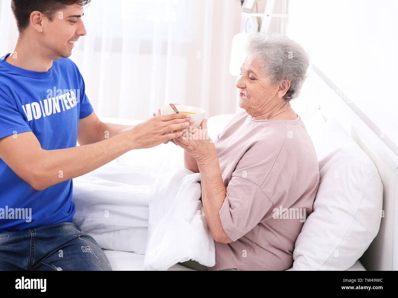 Hospital feeding elderly patient hires stock photography and images