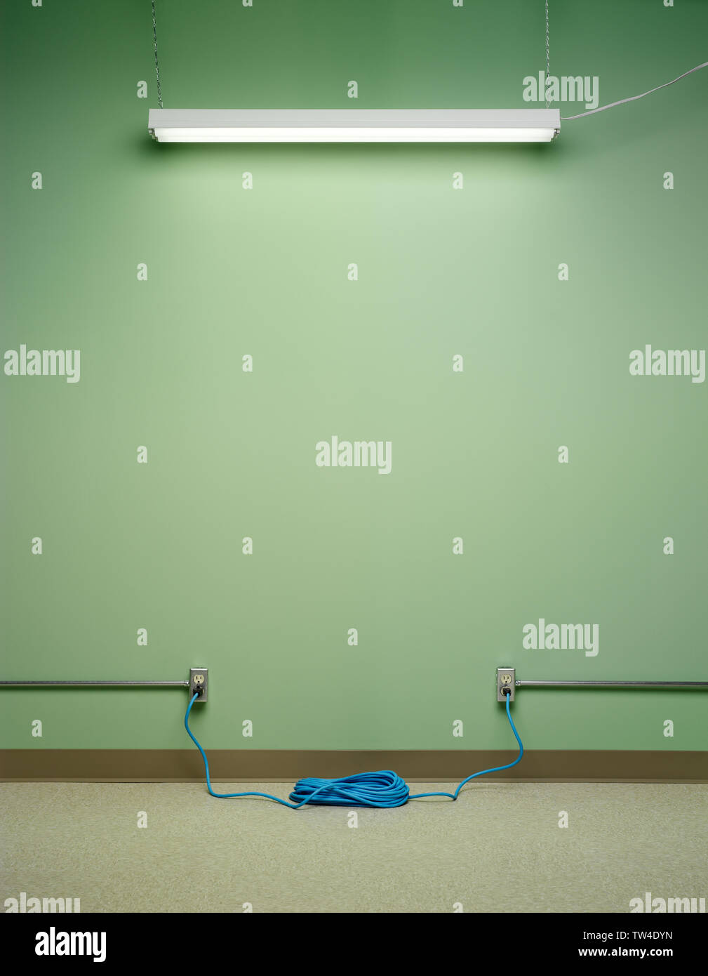 Dangerous electrical circuit, created by blue coiled extension cord