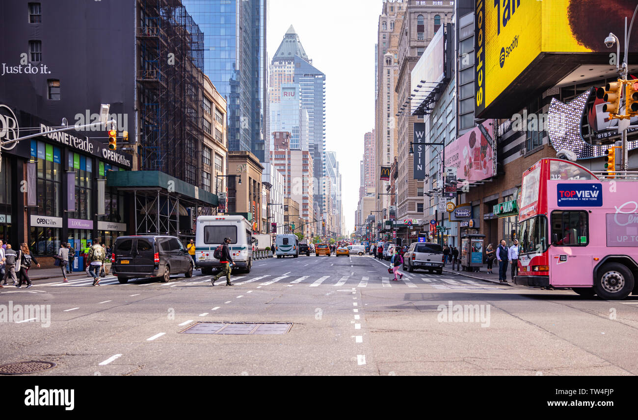 USA, New York, Manhattan streets. May 2, 2019. Skyscrapers, colorful neon signs and ads, cars and people walking Stock Photo