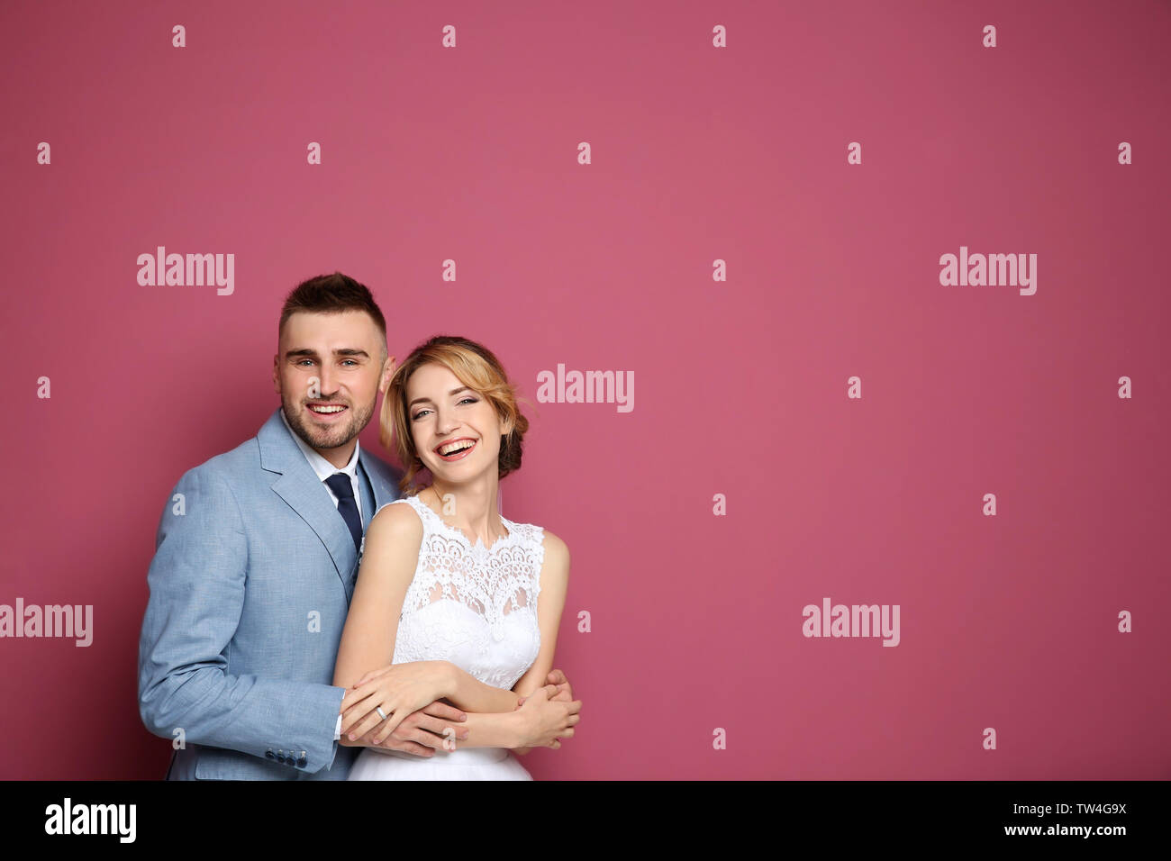 Happy wedding couple on color background Stock Photo - Alamy