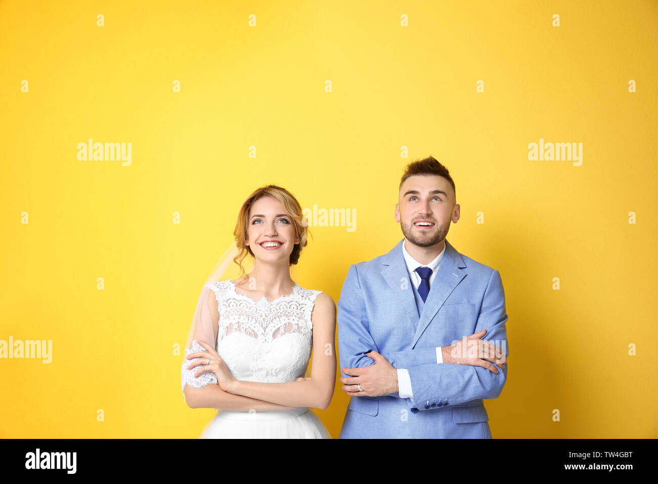 Happy wedding couple on color background Stock Photo - Alamy