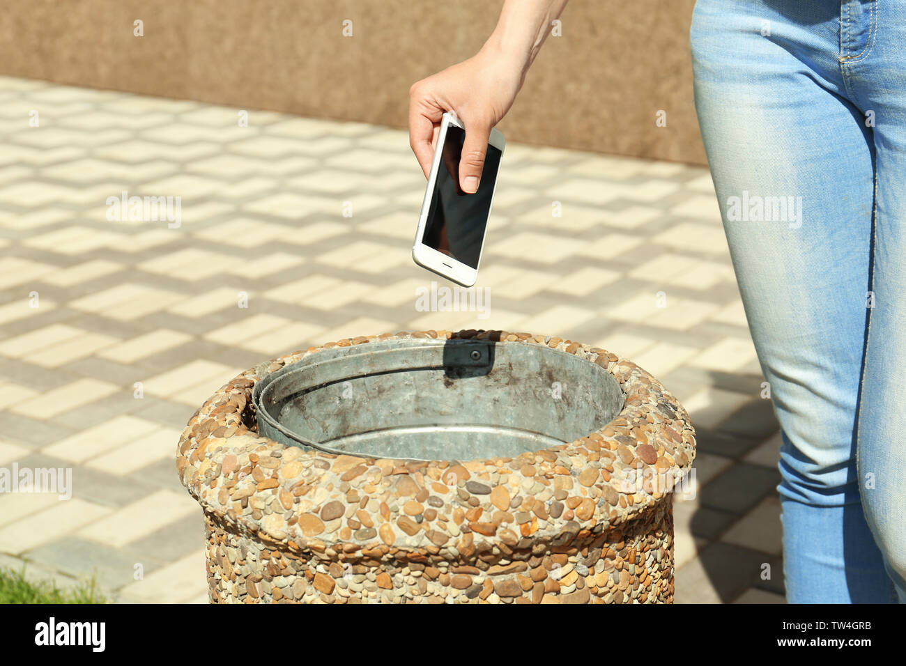 Woman throwing phone in bin hires stock photography and images Alamy
