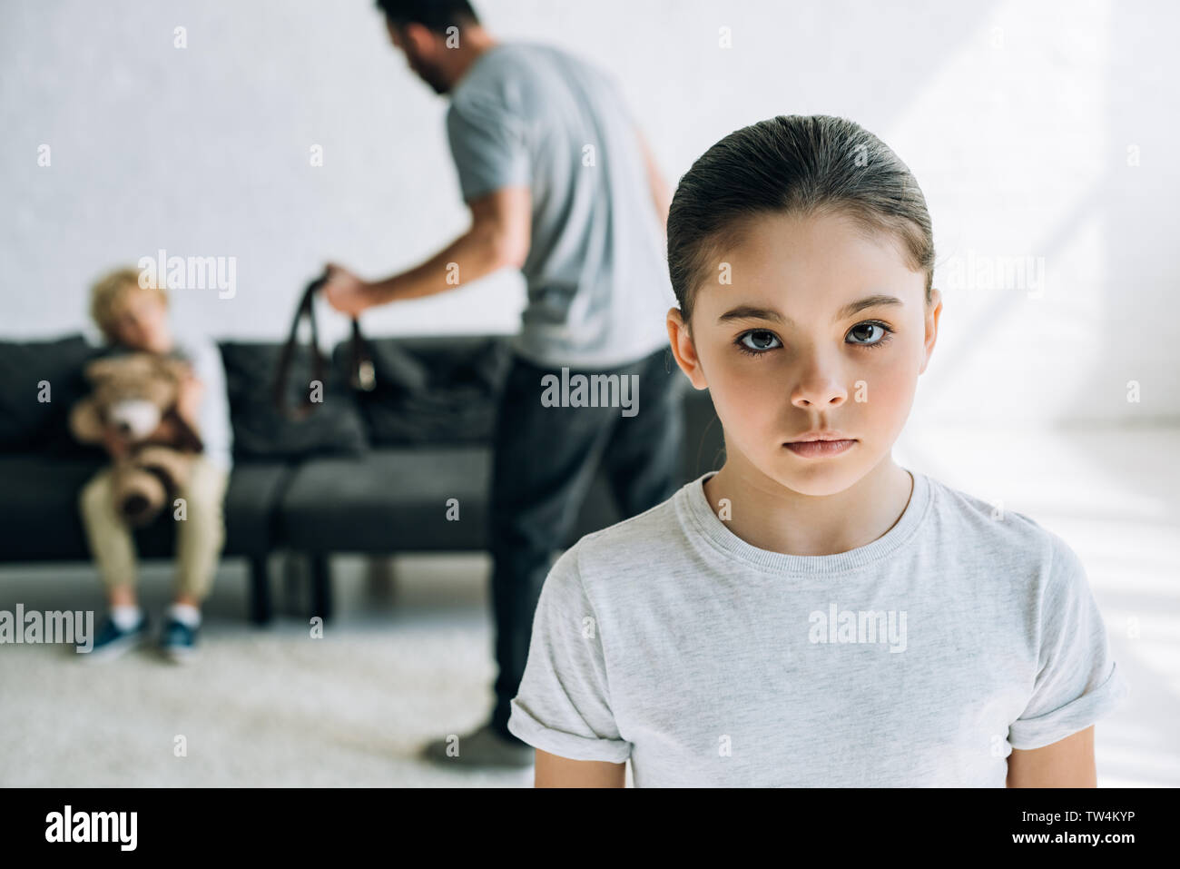 sad children and abusive father holding belt at home Stock Photo
