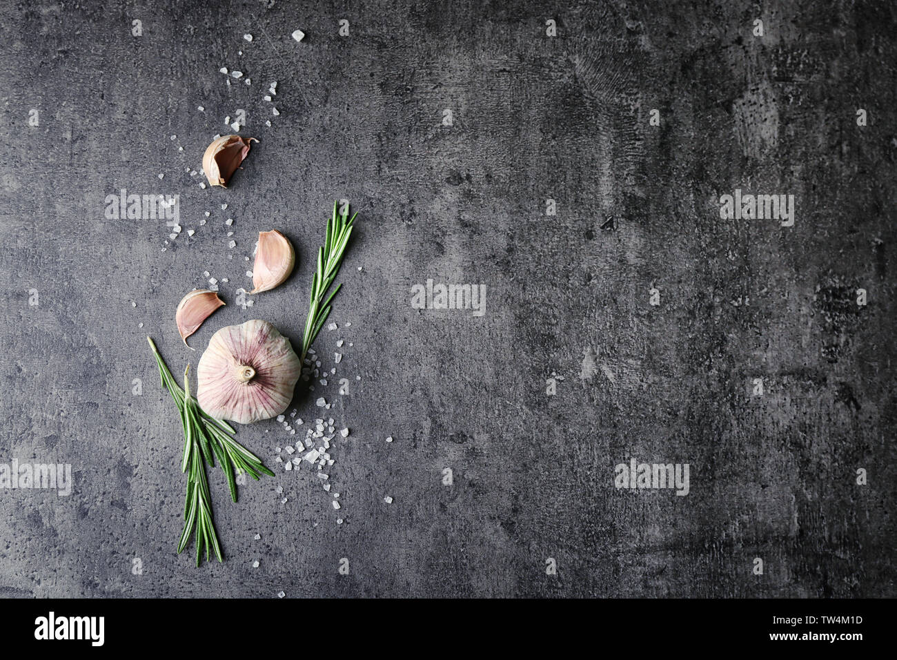 Composition with fresh rosemary and garlic on grey background Stock ...