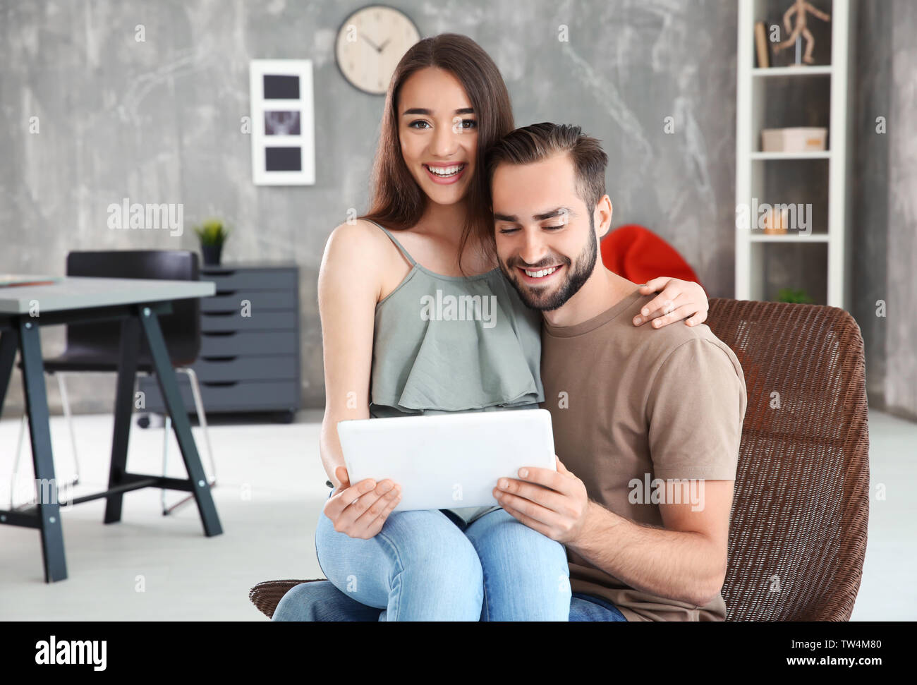 Young couple searching information using tablet at home Stock Photo
