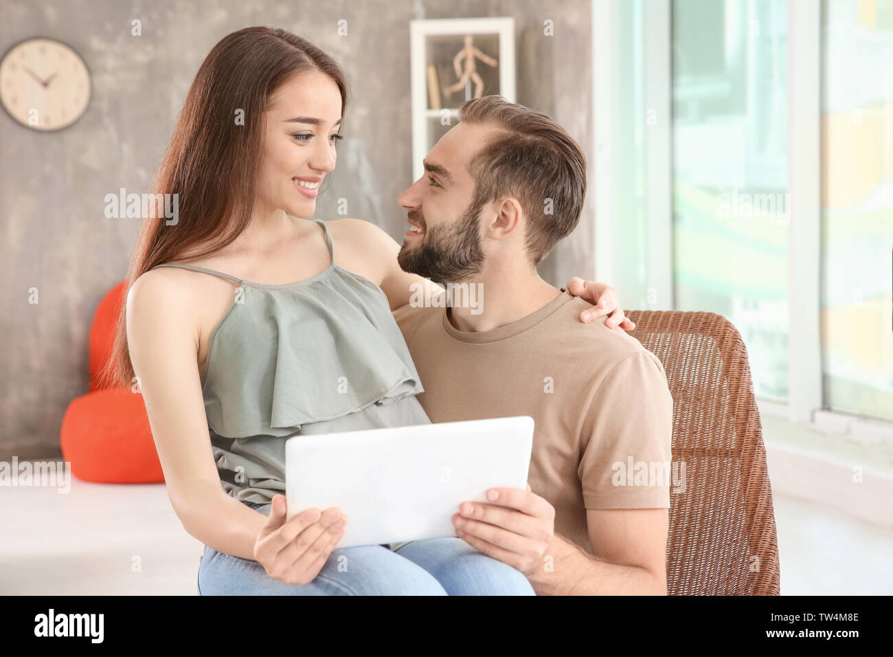 Young couple searching information using tablet at home Stock Photo